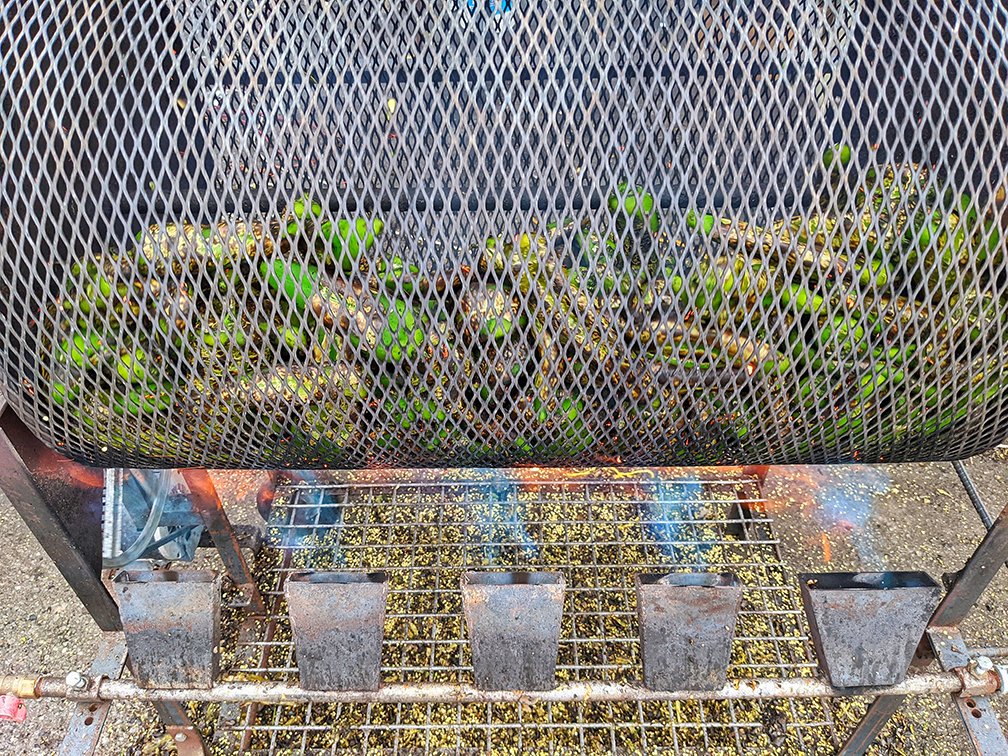 a barrel roaster full of Hatch green chile roasting 