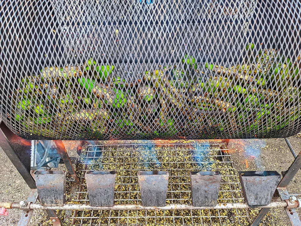 a barrel roaster full of Hatch green chile roasting